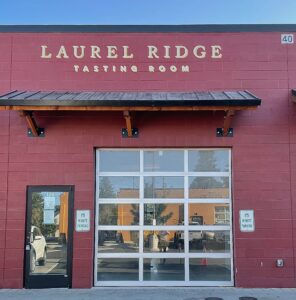 A view of the Laurel Ridge Bend Tasting Room in the Century Center from the front of the building showing the entrance and garage roll up door.